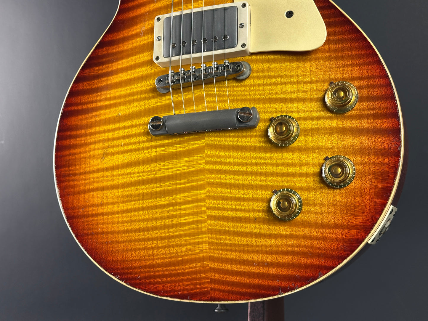 Close-up of a sunburst electric guitar on a dark background