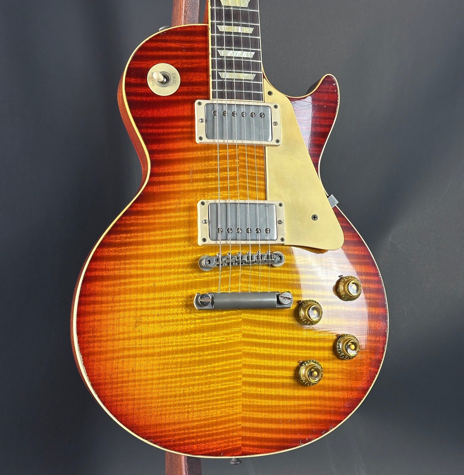 Electric guitar with a sunburst finish on a dark background