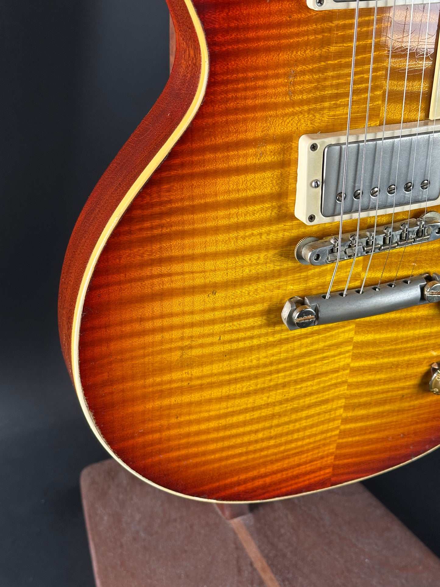 Close-up of a sunburst electric guitar on a dark background
