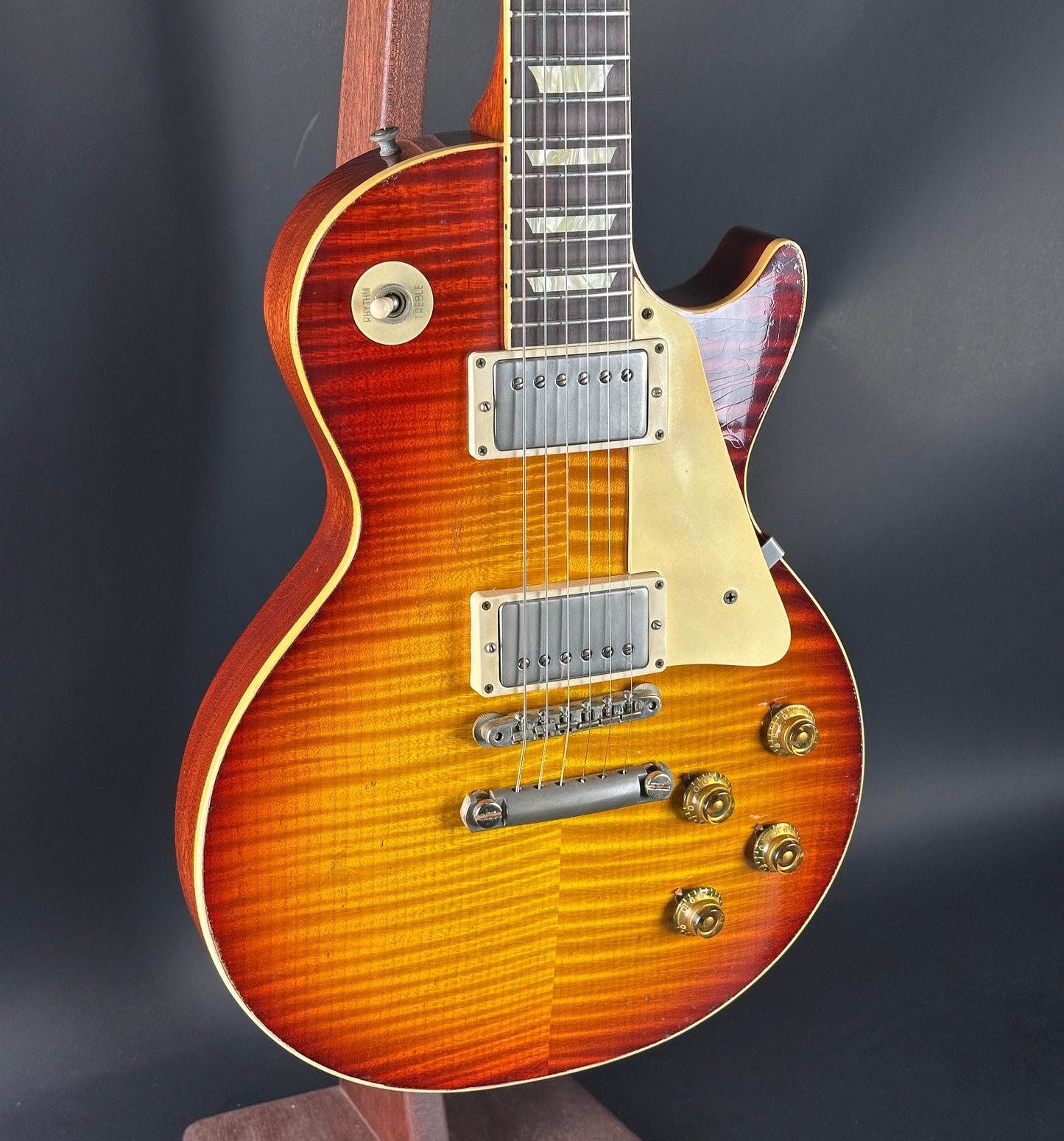 Electric guitar with a sunburst finish on a dark background