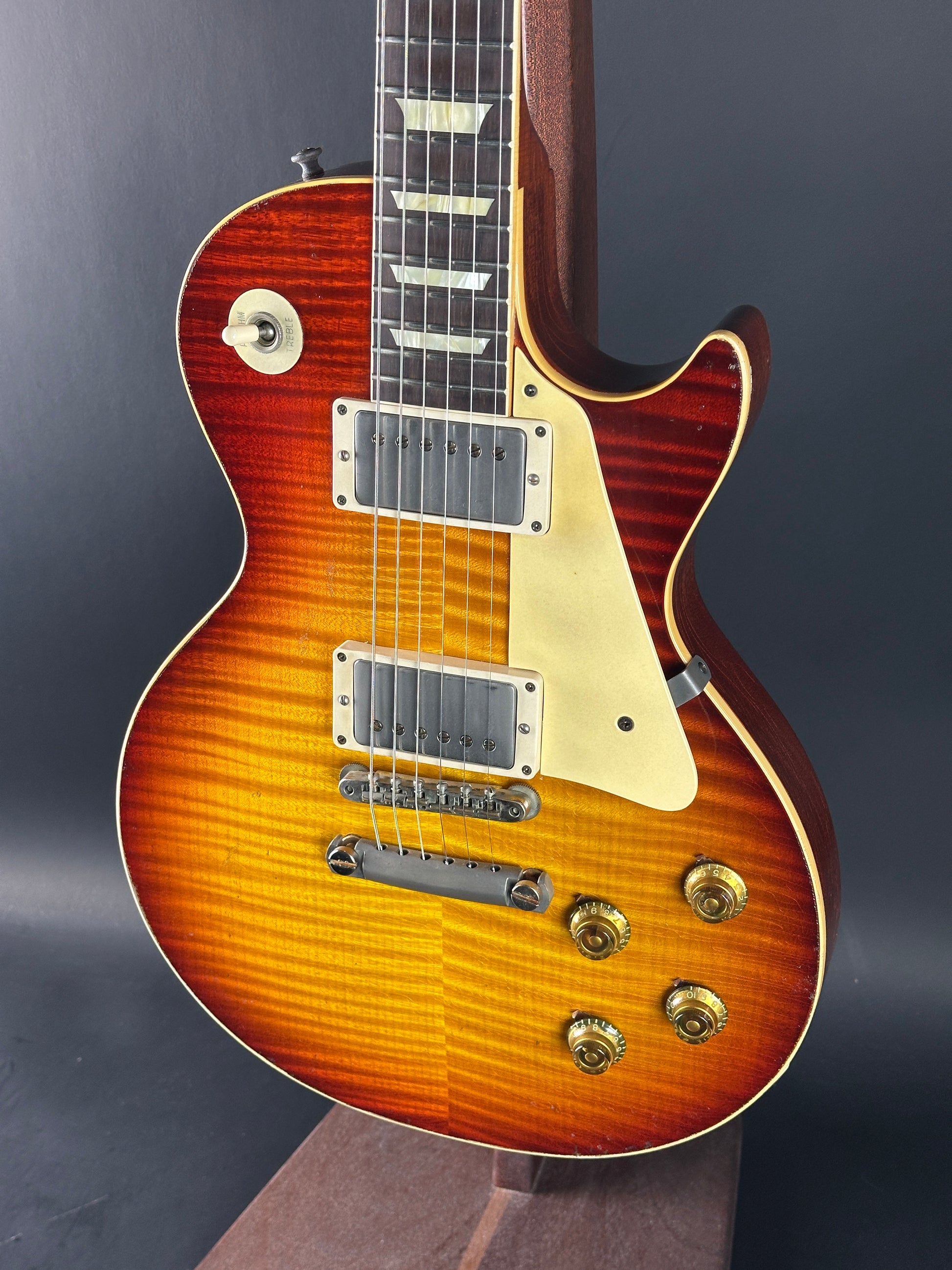 Electric guitar with a sunburst finish on a dark background