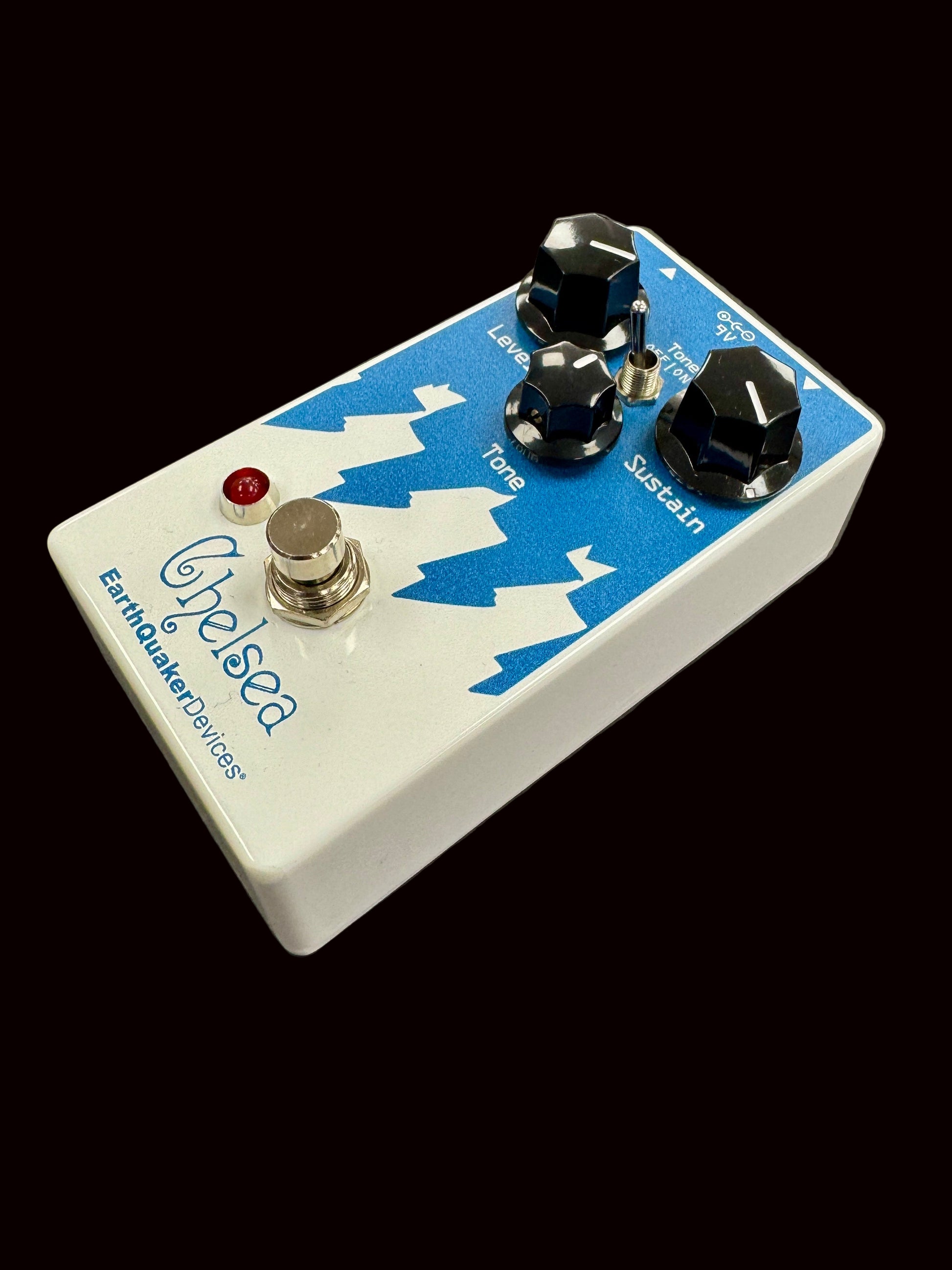 Guitar effects pedal with blue and white design on a gray background