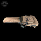 Beige guitar case with 'SE' logo on a black background, featuring the Tone Shop logo.