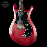 Red electric guitar on a black background with 'Tone Shop' logo.
