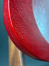 Close-up of a red textured surface with a blurred background