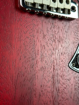 Close-up of a guitar bridge on a wooden surface