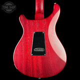 Red electric guitar with a visible brand logo in the corner