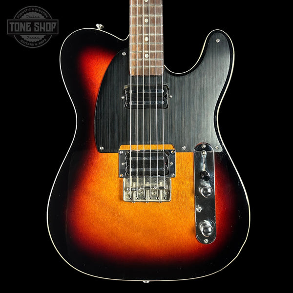 Electric guitar with a sunburst finish on a black background, featuring the Tone Shop logo.