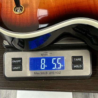 Used Gibson Les Paul Supreme Fireburst on a scale displaying the weight.