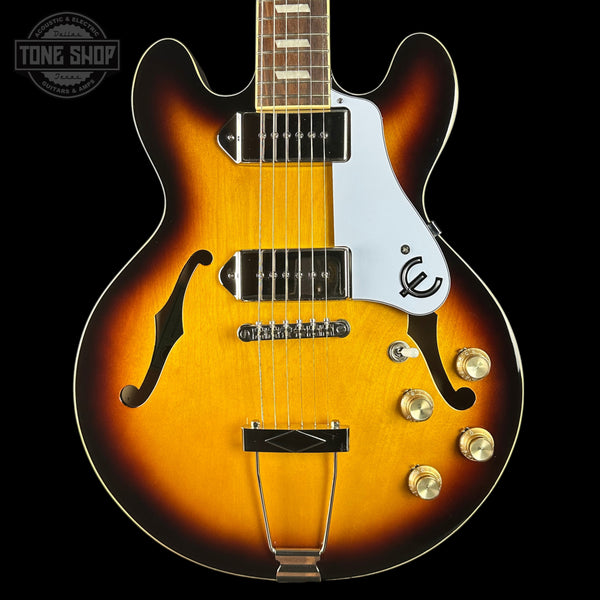 Electric guitar with a sunburst finish on a black background, featuring the 'Tone Shop' logo.