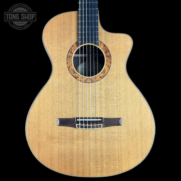 Acoustic guitar with a visible brand logo on a black background