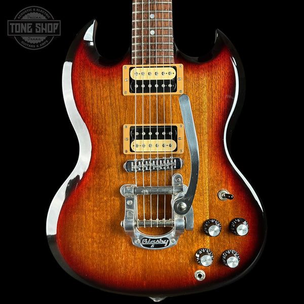 Electric guitar with a sunburst finish on a black background, featuring Gibson branding.