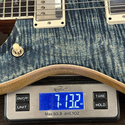Guitar on a digital scale displaying weight