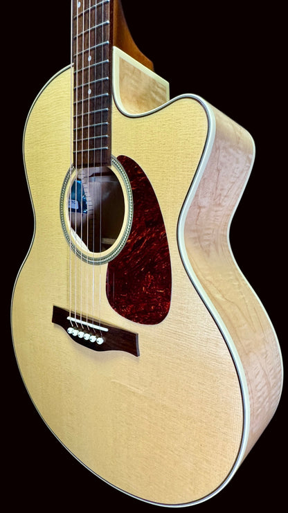 Acoustic guitar with a natural finish on a blue background