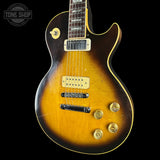 Electric guitar with a sunburst finish on a black background, featuring the 'Tone Shop' logo.