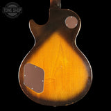 Back of a guitar with a sunburst finish on a black background, featuring the Tone Shop logo.