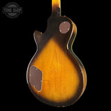 Back view of a sunburst electric guitar with 'Tone Shop' logo.