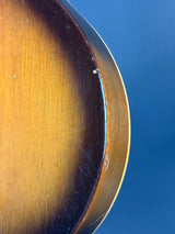 Close-up of a guitar's soundhole with a blue background