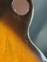 Close-up of a guitar's body with a worn finish