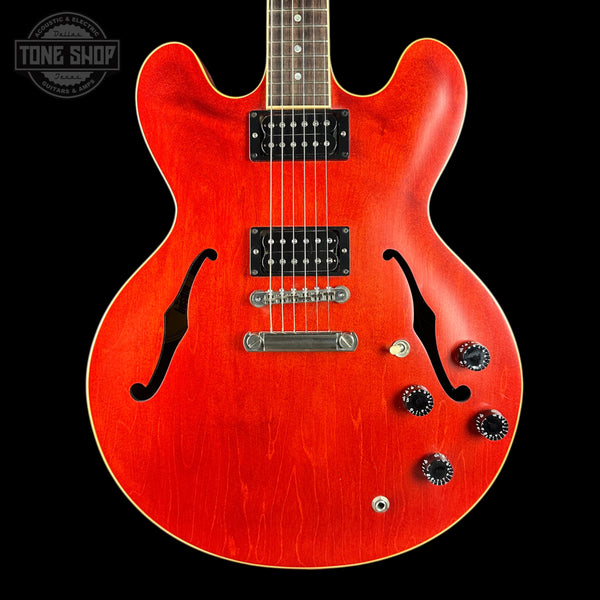 Red electric guitar with a black background