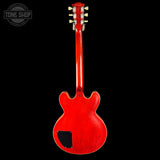 Red electric guitar headstock on a black background with 'Tone Shop' logo.