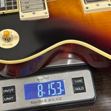 Used Epiphone Inspired by Gibson '59 Les Paul on scale displaying weight.