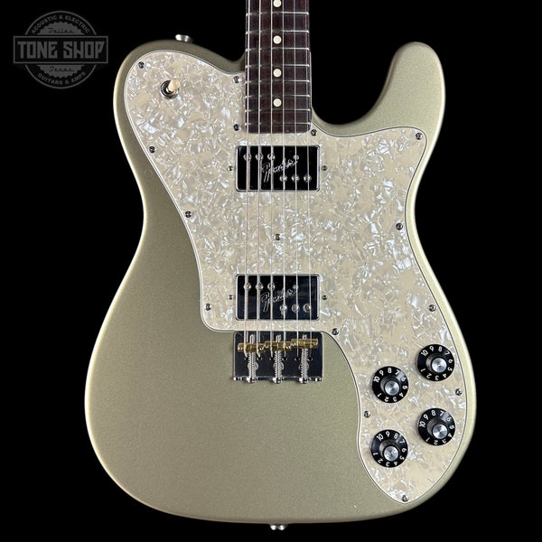 Electric guitar with pearlized pickguard on a black background, featuring 'Tone Shop' logo.