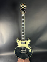 Electric guitar with a black and cream finish on a dark background