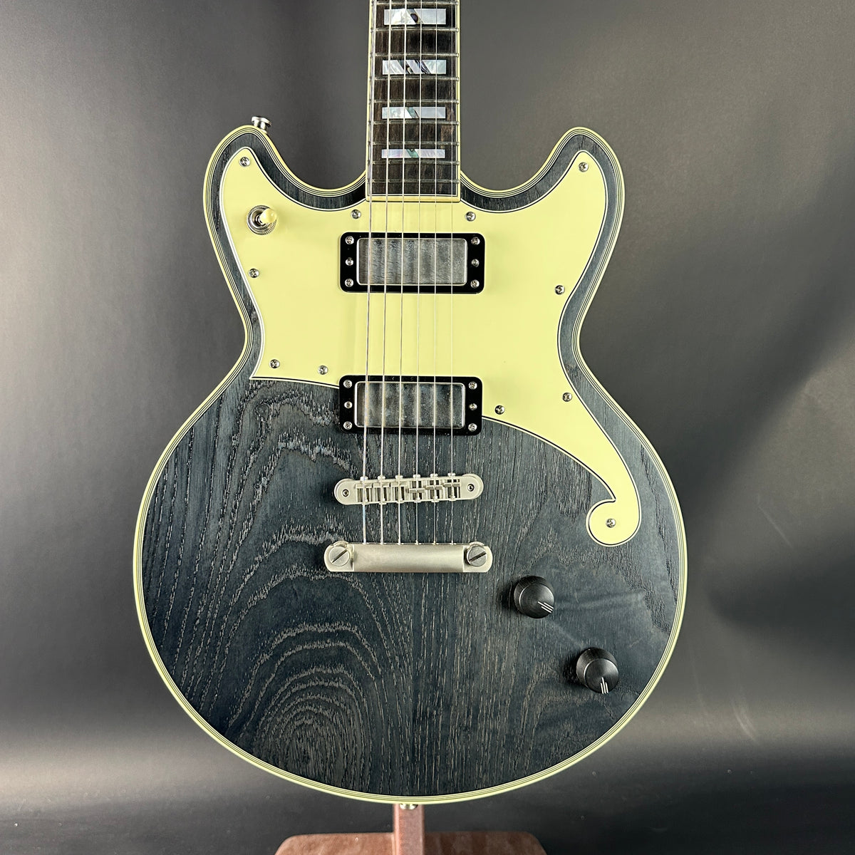 Electric guitar with a black and white design on a dark background