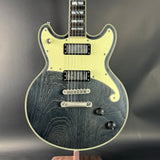 Electric guitar with a black and white design on a dark background