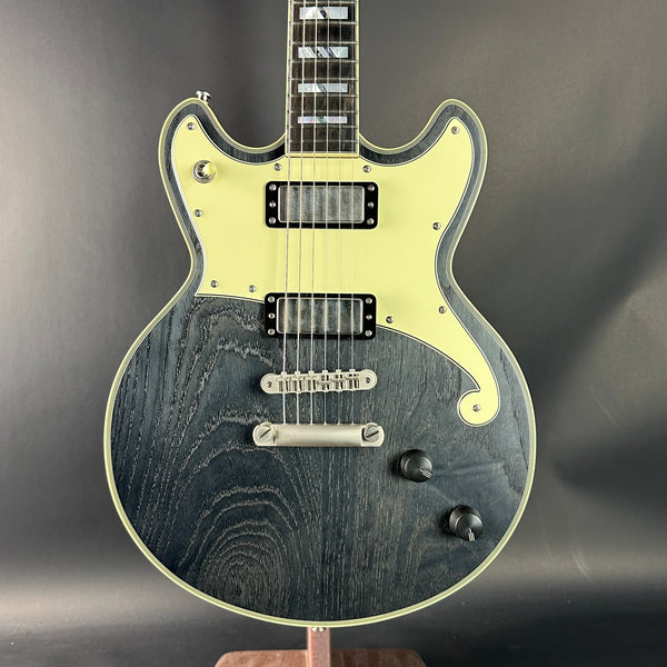 Electric guitar with a black and white design on a dark background