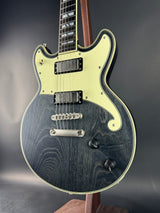 Electric guitar with a black and white design on a dark background