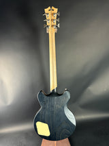 Black electric guitar on a reflective gray surface