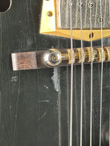 Wear under bridge of Vintage 1960s Silvertone 1446 Black.