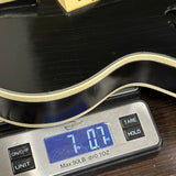 Vintage 1960s Silvertone 1446 Black on scale displaying weight.
