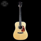 Acoustic guitar with a visible brand logo on a white background