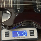 Vintage 1965 Gibson Melody Maker on scale displaying weight.
