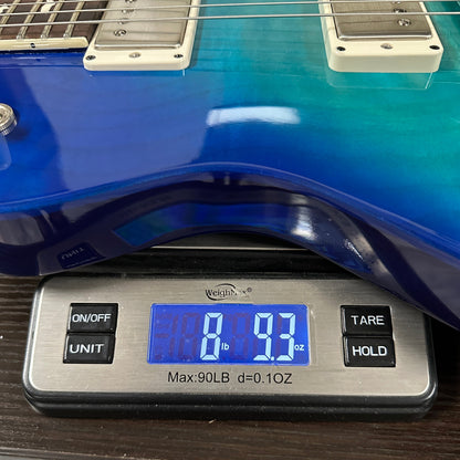 PRS S2 Wood Library McCarty 594 Singlecut Quilt Makena Blue on scale displaying weight.