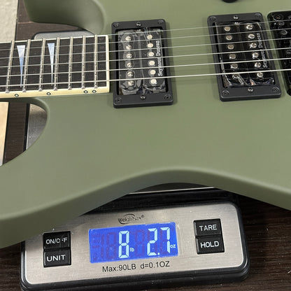 Green electric guitar on a digital scale displaying weight