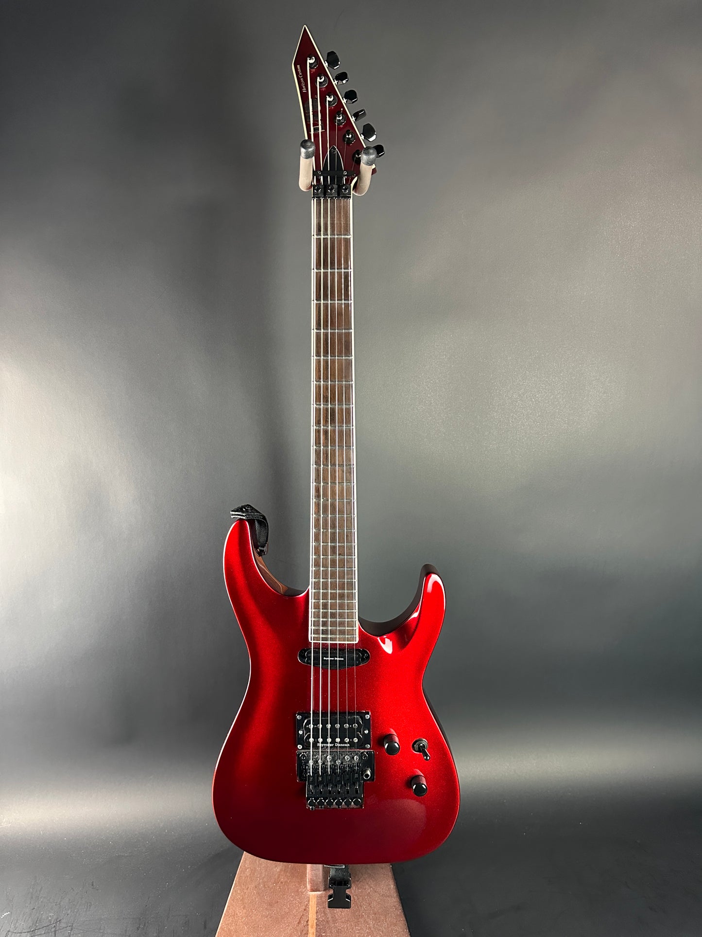 Red electric guitar on a gray background
