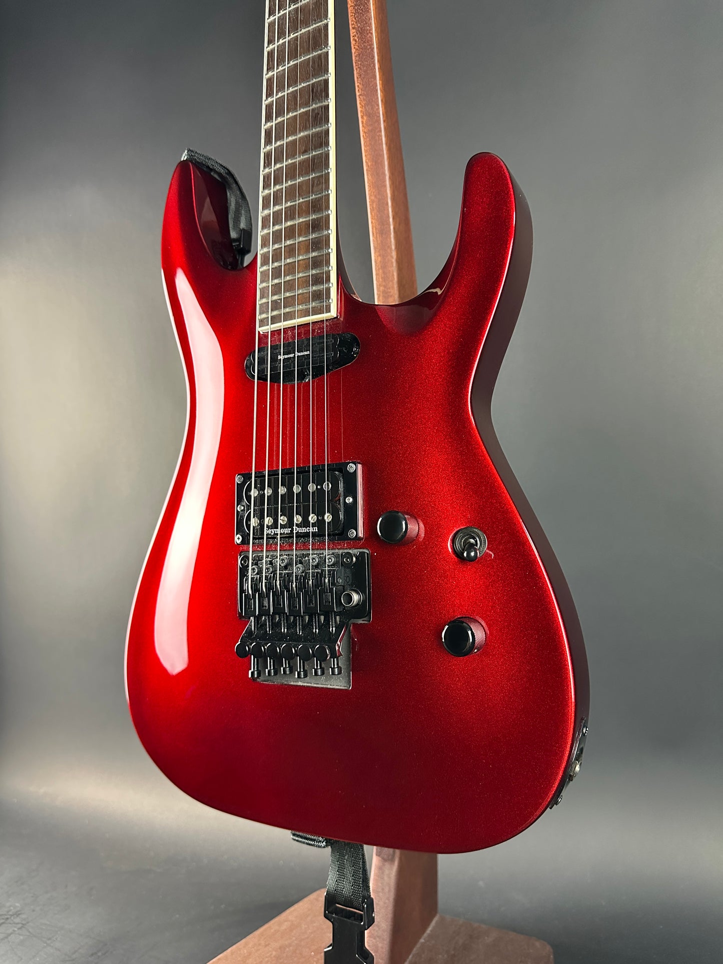 Red electric guitar on a gray background