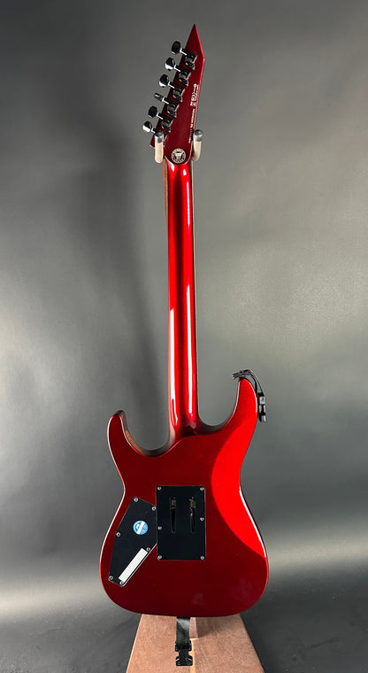 Red electric guitar on a gray background