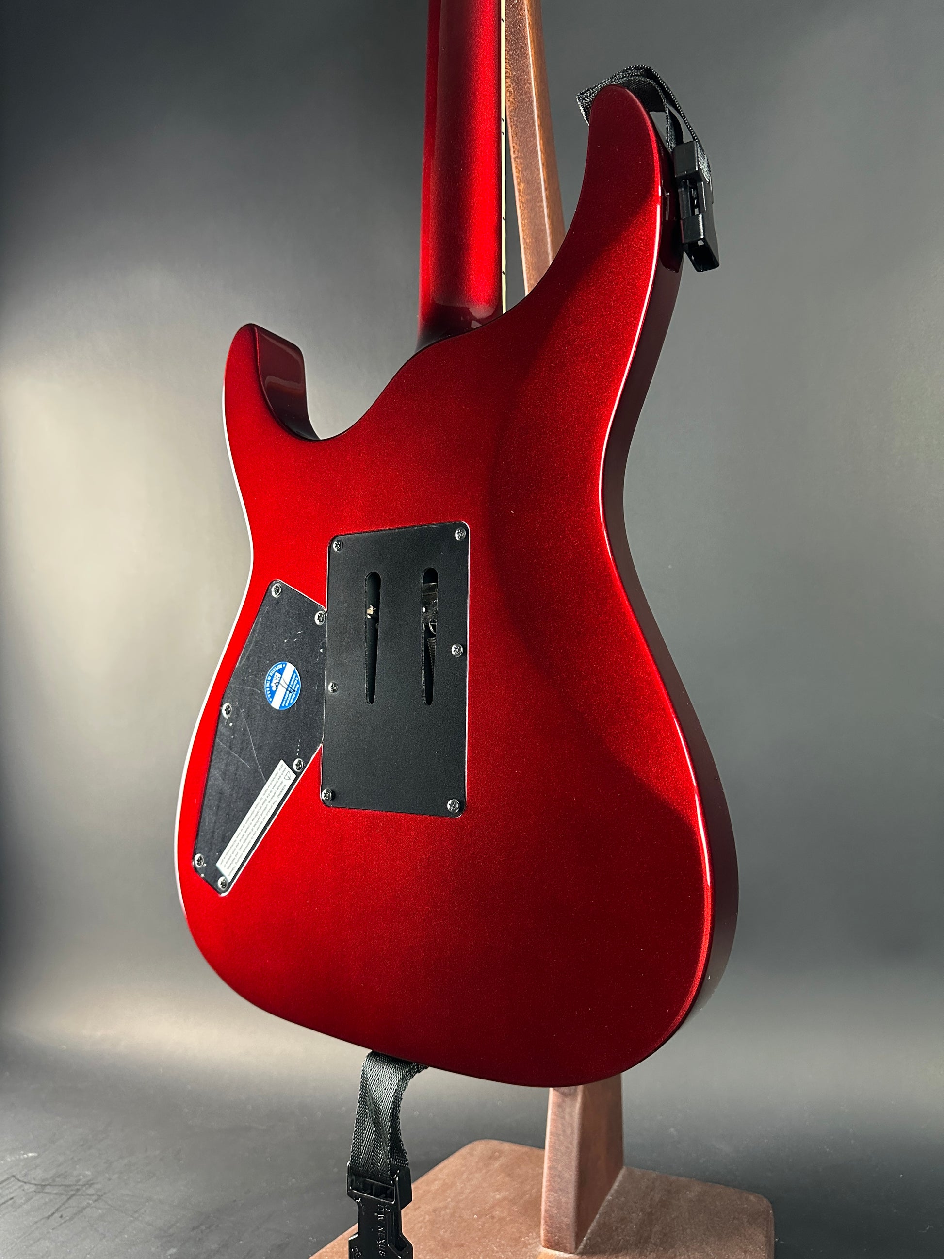 Red electric guitar body on a gray background