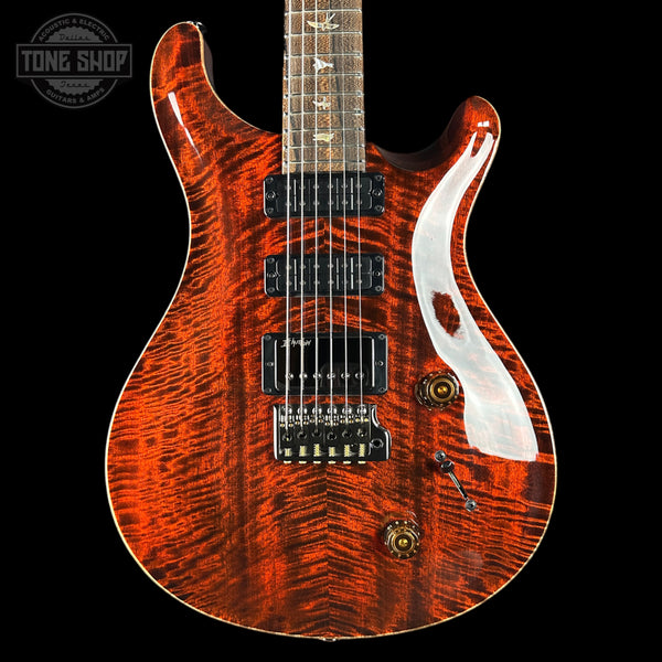 Electric guitar with a distinctive wood finish on a black background, featuring the Tone Shop logo.