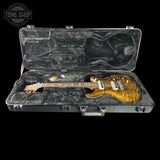Electric guitar in an open case with 'Tone Shop' logo.