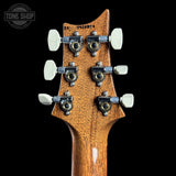 Guitar headstock with tuning pegs on a black background, featuring 'Tone Shop' logo.