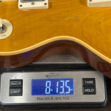 Guitar on a digital scale displaying weight