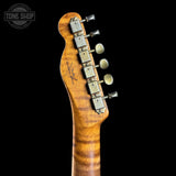 Close-up of a guitar headstock with tuning pegs on a black background, featuring the Tone Shop logo.