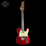 Red electric guitar with a white pickguard on a black background, featuring 'Tone Shop' branding.