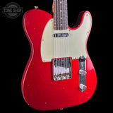 Red electric guitar with a white pickguard on a black background, featuring 'Tone Shop' branding.
